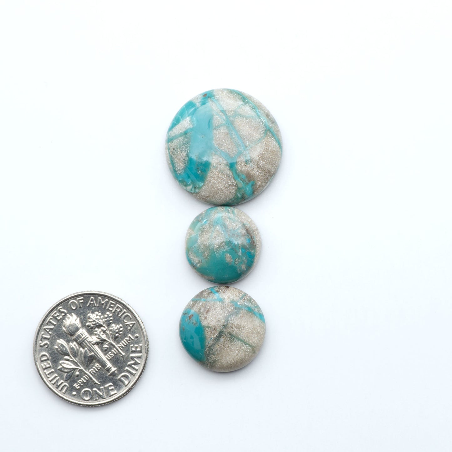 Carico Lake Turquoise cabochons with vibrant aqua-blue to turquoise tones and natural matrix, ideal for rings, pendants, and artisan jewelry.