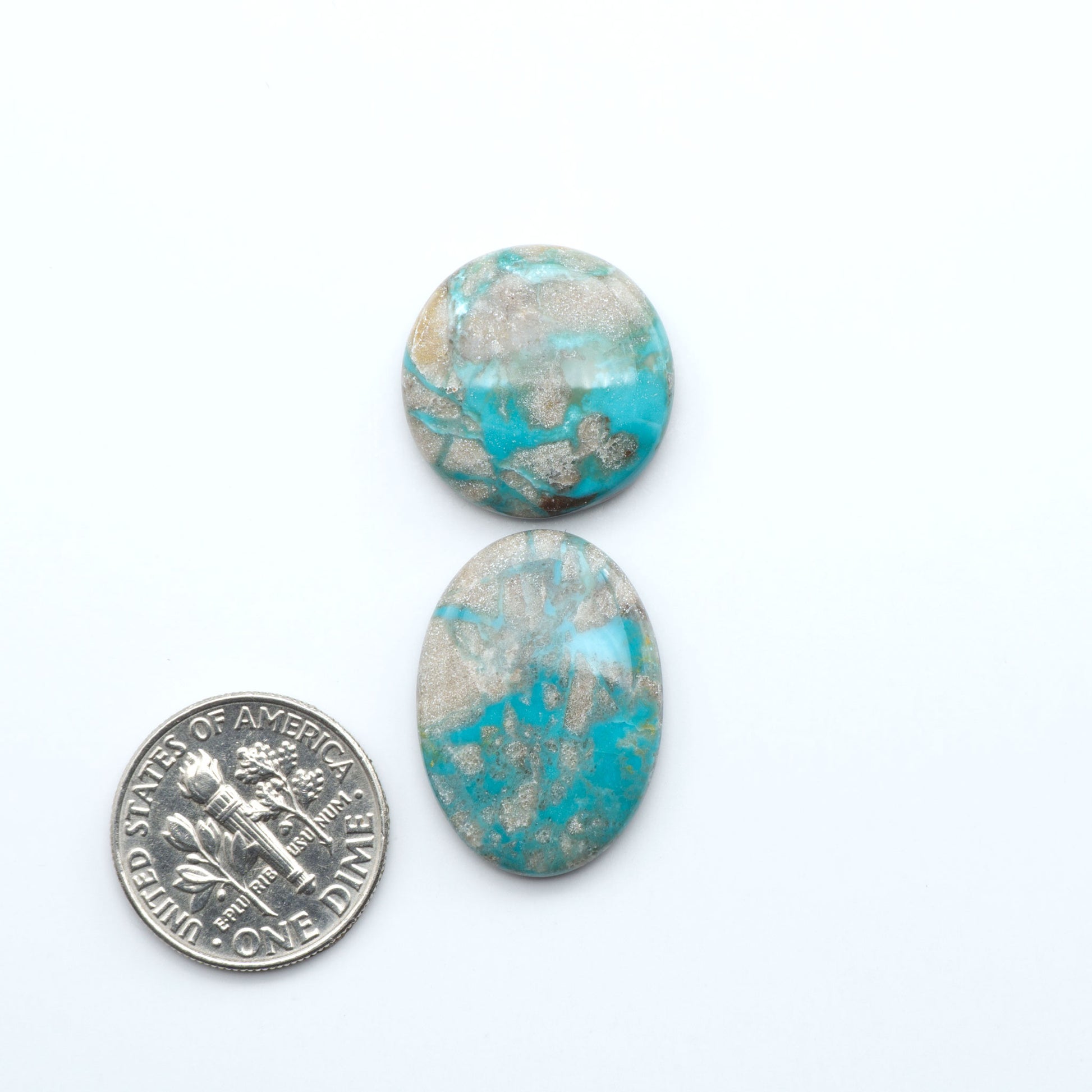 Carico Lake Turquoise cabochons with vibrant aqua-blue to turquoise tones and natural matrix, ideal for rings, pendants, and artisan jewelry.
