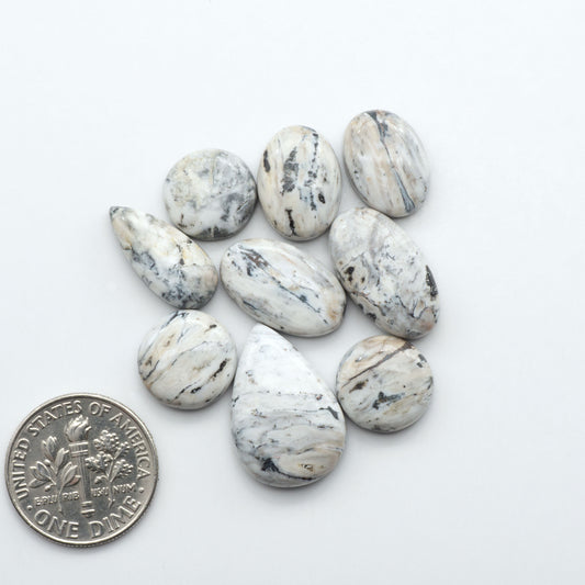 Natural White Buffalo Stone Cabochons are semi-precious gemstones cut into shapes ideal for jewelry-making, making them an excellent choice for artisans.