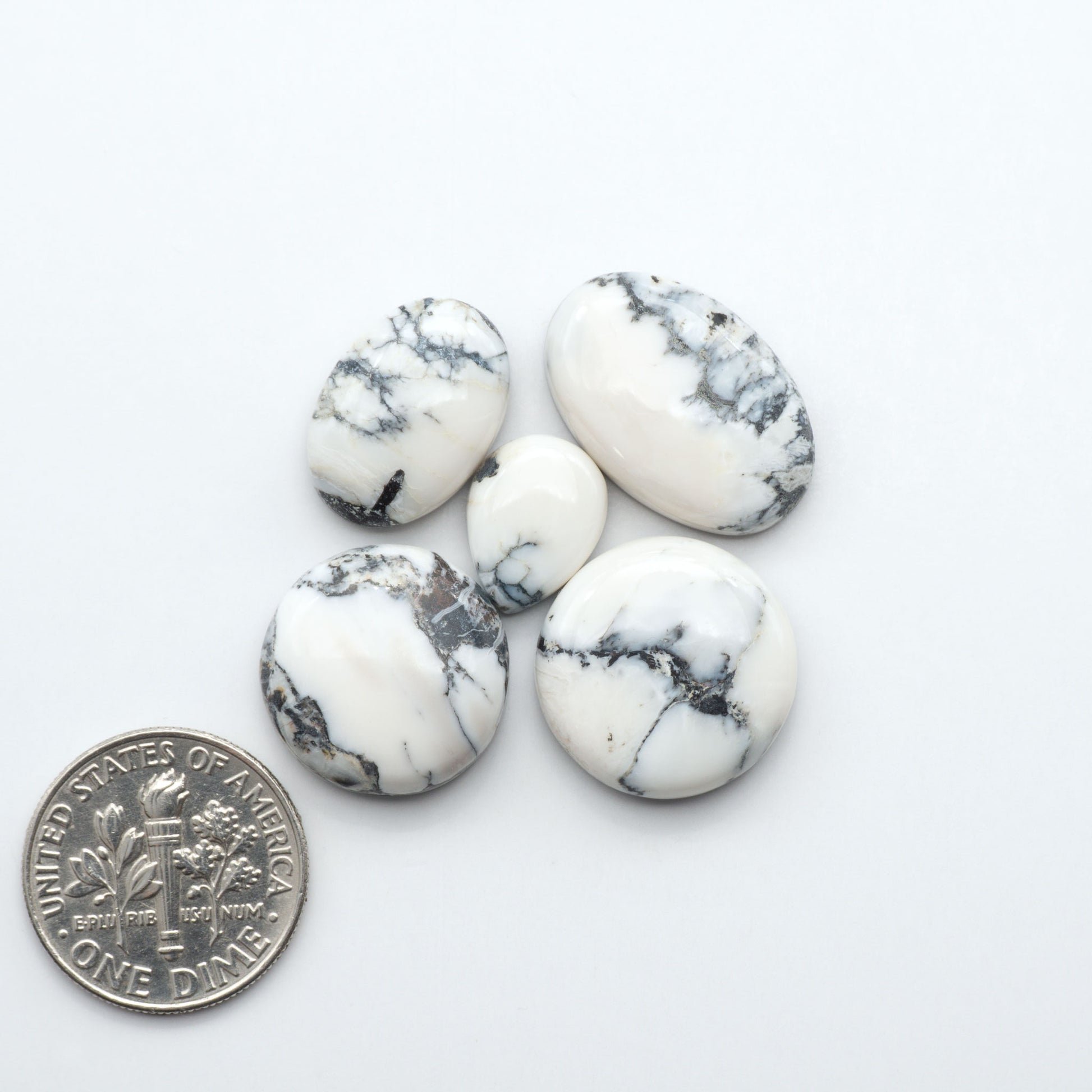 Natural White Buffalo Stone Cabochons are semi-precious gemstones cut into shapes ideal for jewelry-making, making them an excellent choice for artisans.