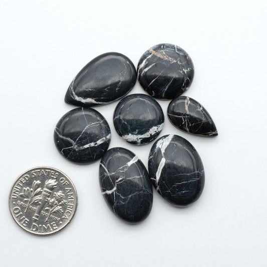 Natural White Buffalo Stone Cabochons are semi-precious gemstones cut into shapes ideal for jewelry-making, making them an excellent choice for artisans.