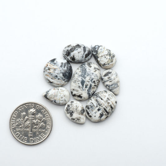 Natural White Buffalo Stone Cabochons are semi-precious gemstones cut into shapes ideal for jewelry-making, making them an excellent choice for artisans.
