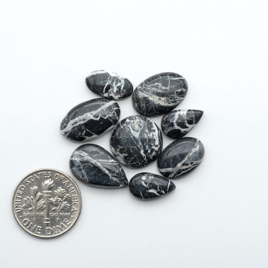 Natural White Buffalo Stone Cabochons are semi-precious gemstones cut into shapes ideal for jewelry-making, making them an excellent choice for artisans.
