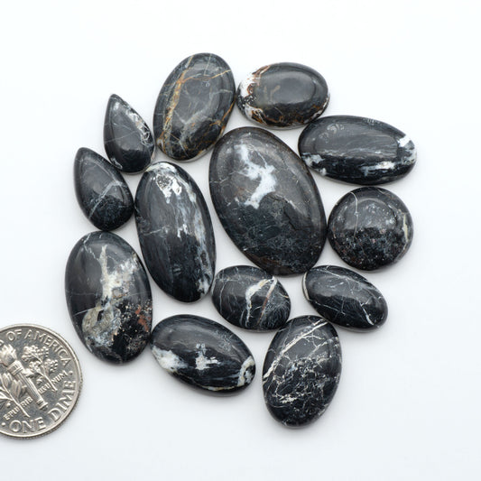 Natural White Buffalo Stone Cabochons are semi-precious gemstones cut into shapes ideal for jewelry-making, making them an excellent choice for artisans.