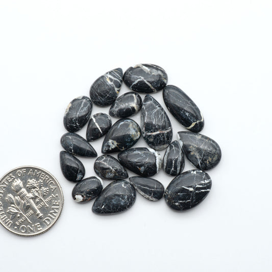 Natural White Buffalo Stone Cabochons are semi-precious gemstones cut into shapes ideal for jewelry-making, making them an excellent choice for artisans.