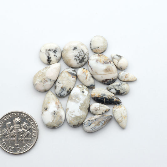 Natural White Buffalo Stone Cabochons are semi-precious gemstones cut into shapes ideal for jewelry-making, making them an excellent choice for artisans.
