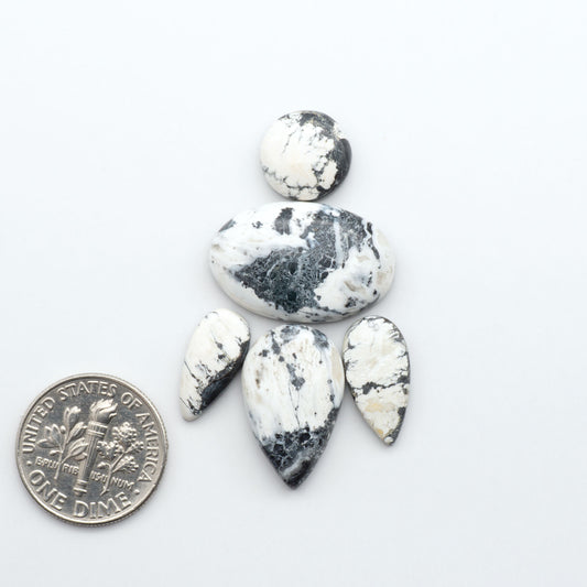 Natural White Buffalo Stone Cabochons are semi-precious gemstones cut into shapes ideal for jewelry-making, making them an excellent choice for artisans.