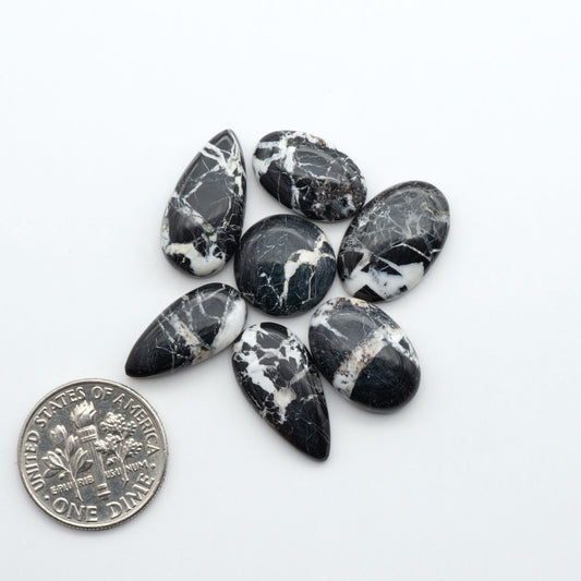 Natural White Buffalo Stone Cabochons are semi-precious gemstones cut into shapes ideal for jewelry-making, making them an excellent choice for artisans.