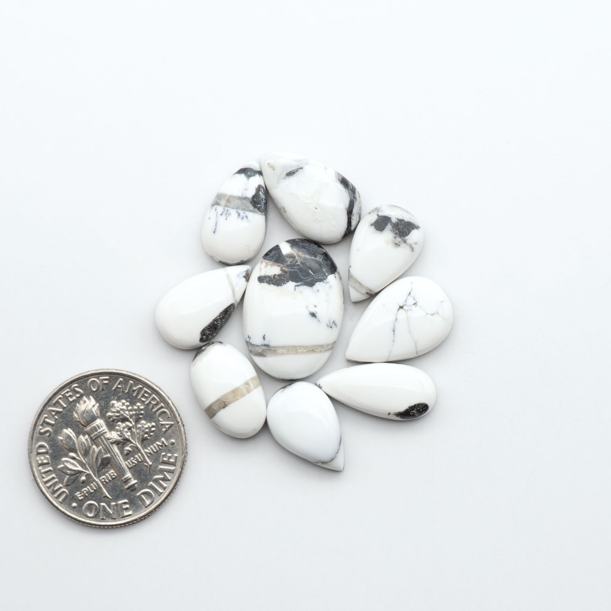 Natural White Buffalo Stone Cabochons are semi-precious gemstones cut into shapes ideal for jewelry-making, making them an excellent choice for artisans.