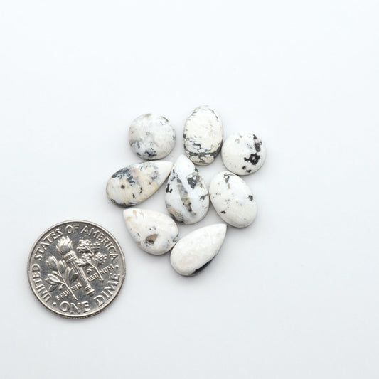 Natural White Buffalo Stone Cabochons are semi-precious gemstones cut into shapes ideal for jewelry-making, making them an excellent choice for artisans.