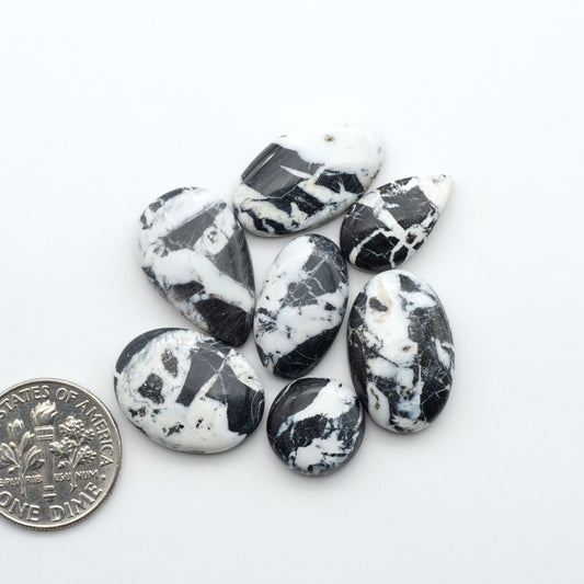 Natural White Buffalo Stone Cabochons are semi-precious gemstones cut into shapes ideal for jewelry-making, making them an excellent choice for artisans.