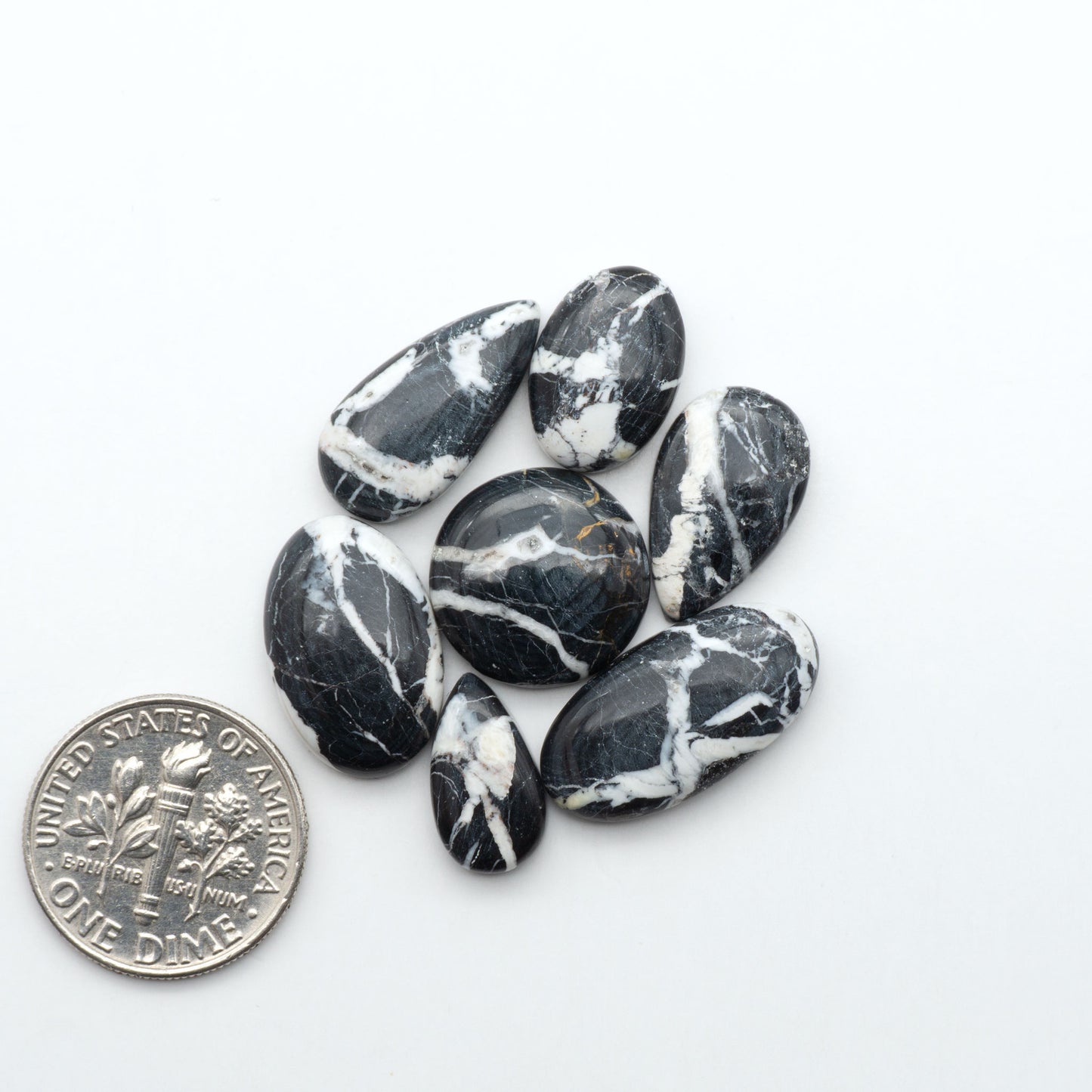 Natural White Buffalo Stone Cabochons are semi-precious gemstones cut into shapes ideal for jewelry-making, making them an excellent choice for artisans.