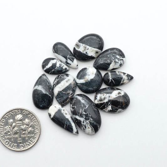 Natural White Buffalo Stone Cabochons are semi-precious gemstones cut into shapes ideal for jewelry-making, making them an excellent choice for artisans.