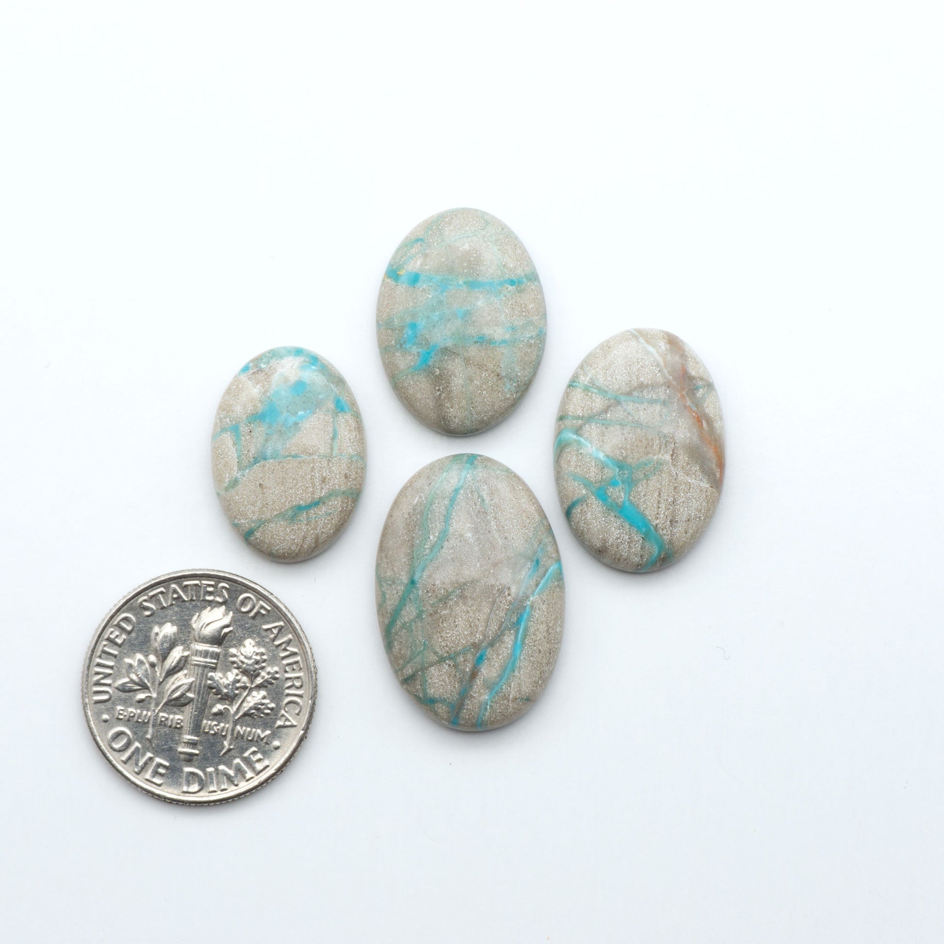 Carico Lake Turquoise cabochons with vibrant aqua-blue to turquoise tones and natural matrix, ideal for rings, pendants, and artisan jewelry.