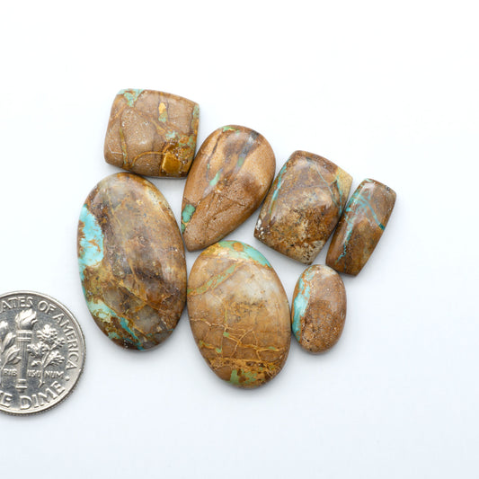 Royston Turquoise cabochons are famous for their distinctive matrix and unique green and blue hues, making them a favored option among jewelry designers.