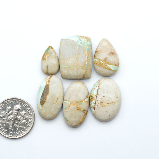 Royston Turquoise cabochons are famous for their distinctive matrix and unique green and blue hues, making them a favored option among jewelry designers.