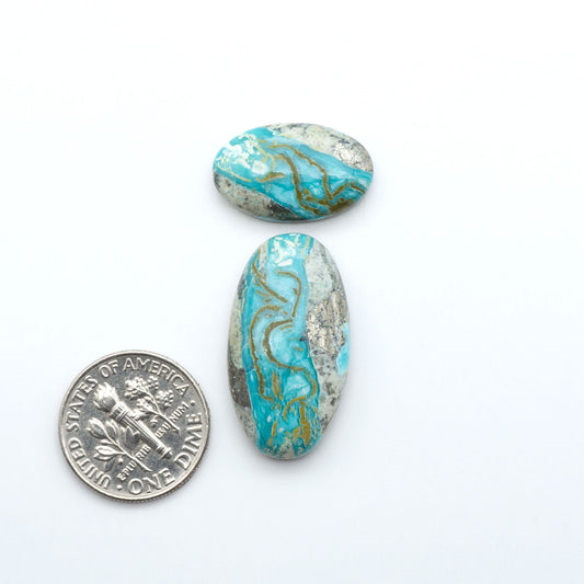 Royston Turquoise cabochons are famous for their distinctive matrix and unique green and blue hues, making them a favored option among jewelry designers.