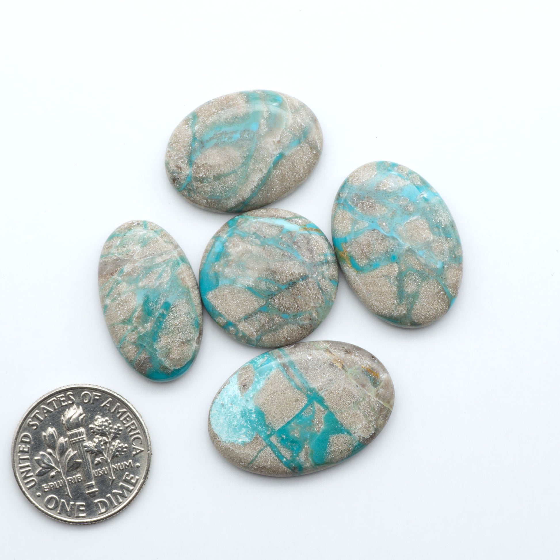 Carico Lake Turquoise cabochons with vibrant aqua-blue to turquoise tones and natural matrix, ideal for rings, pendants, and artisan jewelry.
