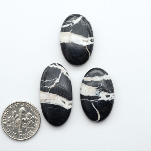 Natural White Buffalo Stone Cabochons are semi-precious gemstones cut into shapes ideal for jewelry-making, making them an excellent choice for artisans.