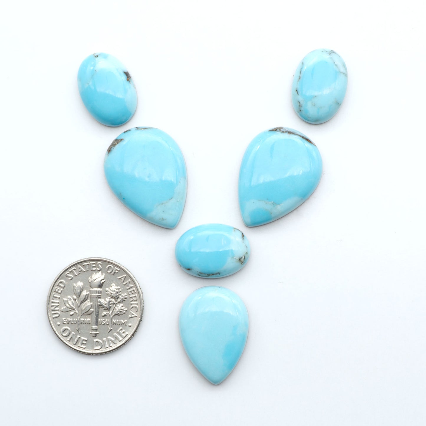 Enhance your jewelry designs with Pressed Turquoise Nugget Cabochons. Crafted from composite materials they add a captivating touch to your creations.