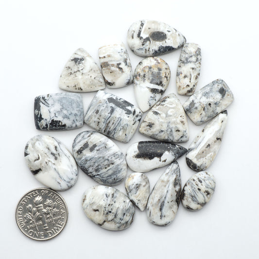 Natural White Buffalo Stone Cabochons are semi-precious gemstones cut into shapes ideal for jewelry-making, making them an excellent choice for artisans.