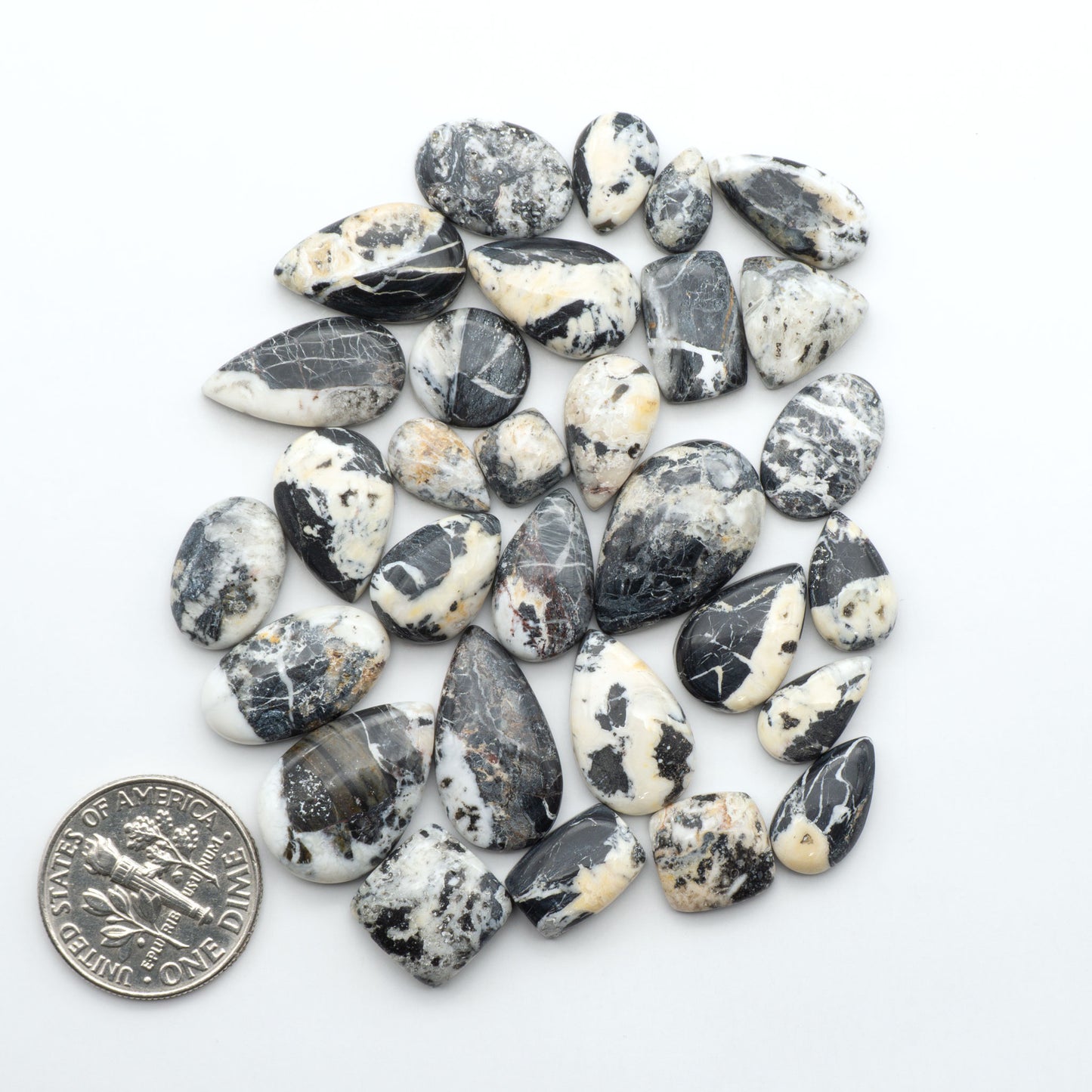 Natural White Buffalo Stone Cabochons are semi-precious gemstones cut into shapes ideal for jewelry-making, making them an excellent choice for artisans.