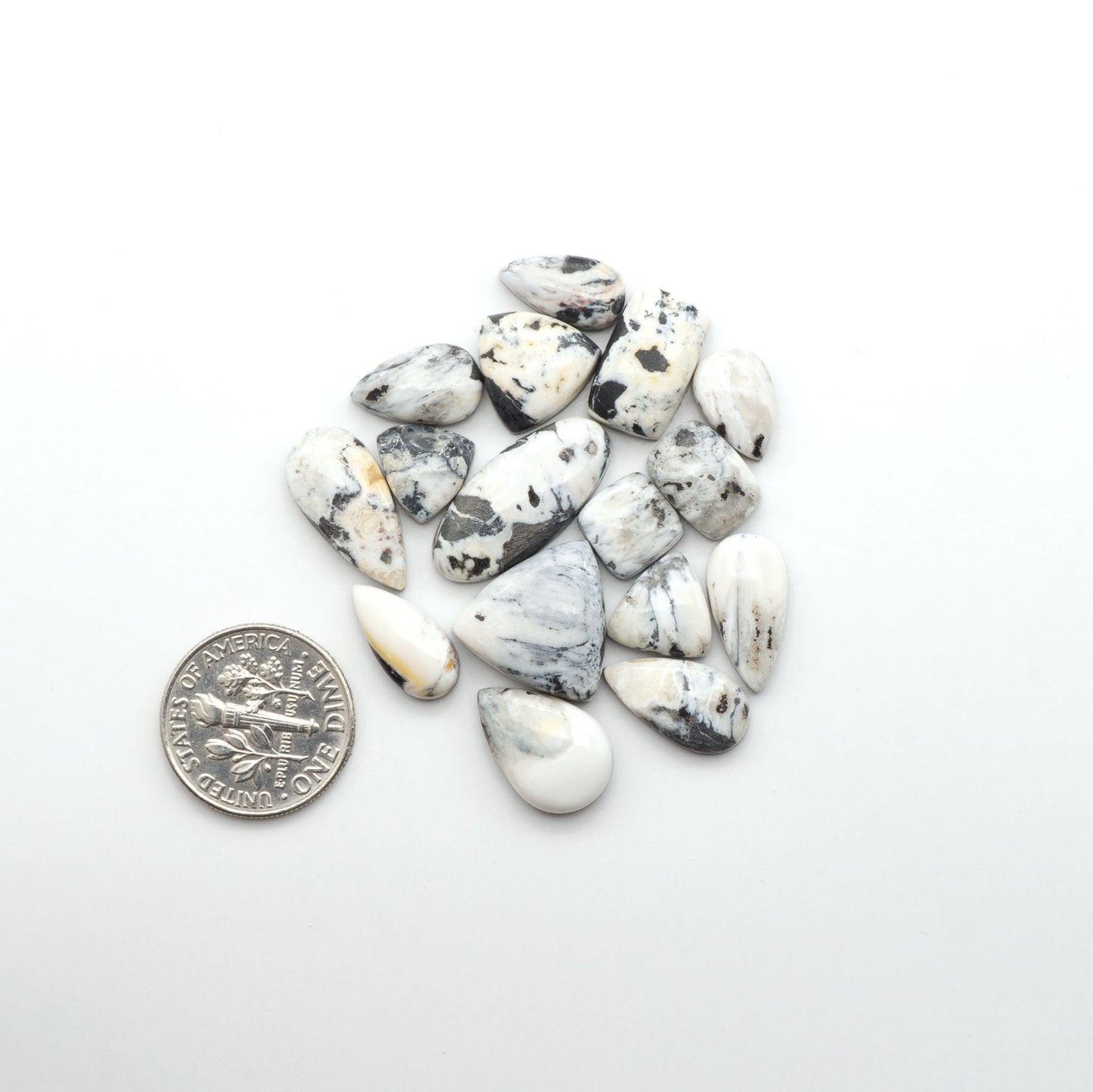 Natural White Buffalo Stone Cabochons are semi-precious gemstones cut into shapes ideal for jewelry-making, making them an excellent choice for artisans.