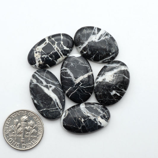 Natural White Buffalo Stone Cabochons are semi-precious gemstones cut into shapes ideal for jewelry-making, making them an excellent choice for artisans.
