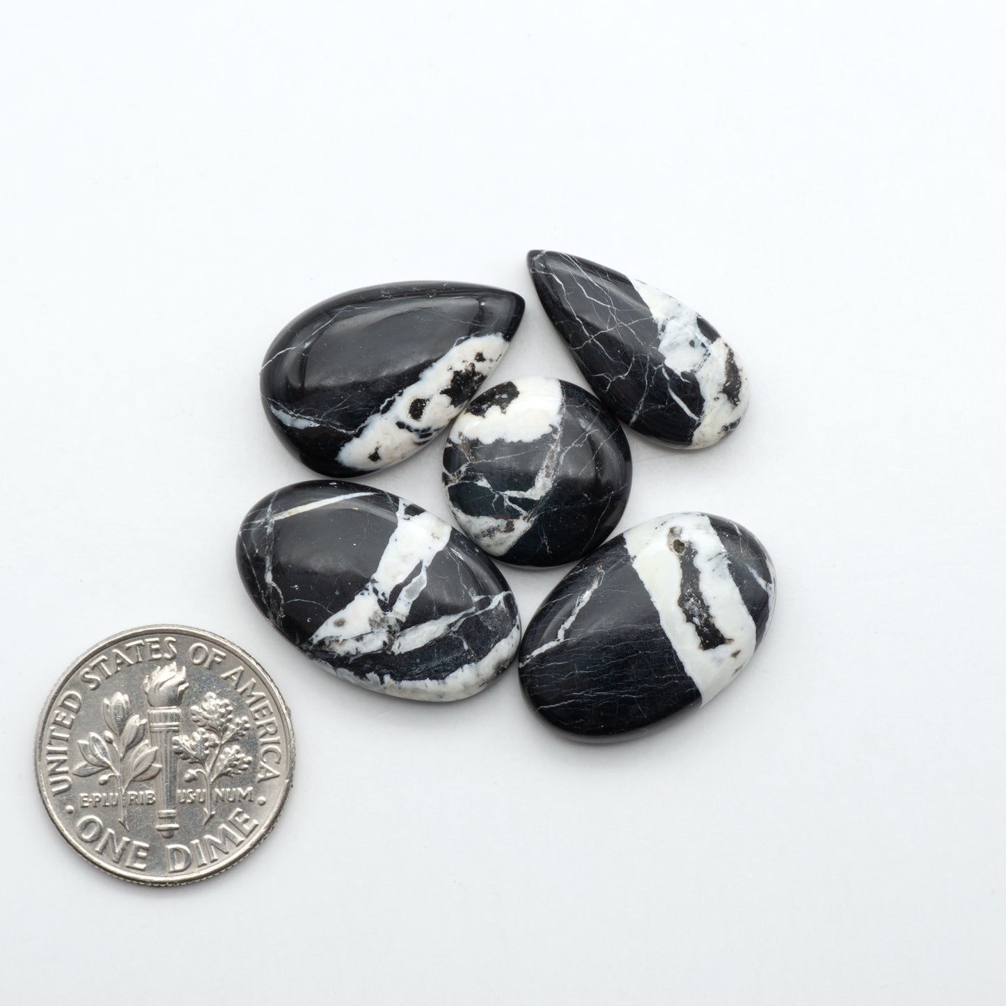 Natural White Buffalo Stone Cabochons are semi-precious gemstones cut into shapes ideal for jewelry-making, making them an excellent choice for artisans.