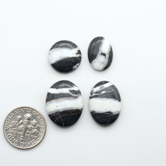 Natural White Buffalo Stone Cabochons are semi-precious gemstones cut into shapes ideal for jewelry-making, making them an excellent choice for artisans.