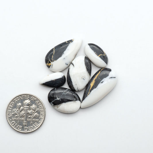 Natural White Buffalo Stone Cabochons are semi-precious gemstones cut into shapes ideal for jewelry-making, making them an excellent choice for artisans.