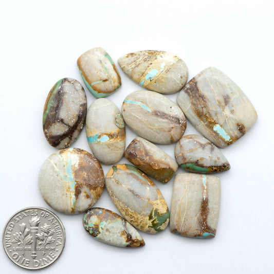 Royston Turquoise cabochons, blue-green color with natural matrix, polished stones on a white background, with a US dime for scale