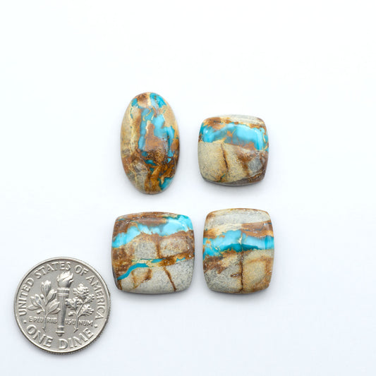 Royston Turquoise cabochons, blue-green color with natural matrix, polished stones on a white background, with a US dime for scale