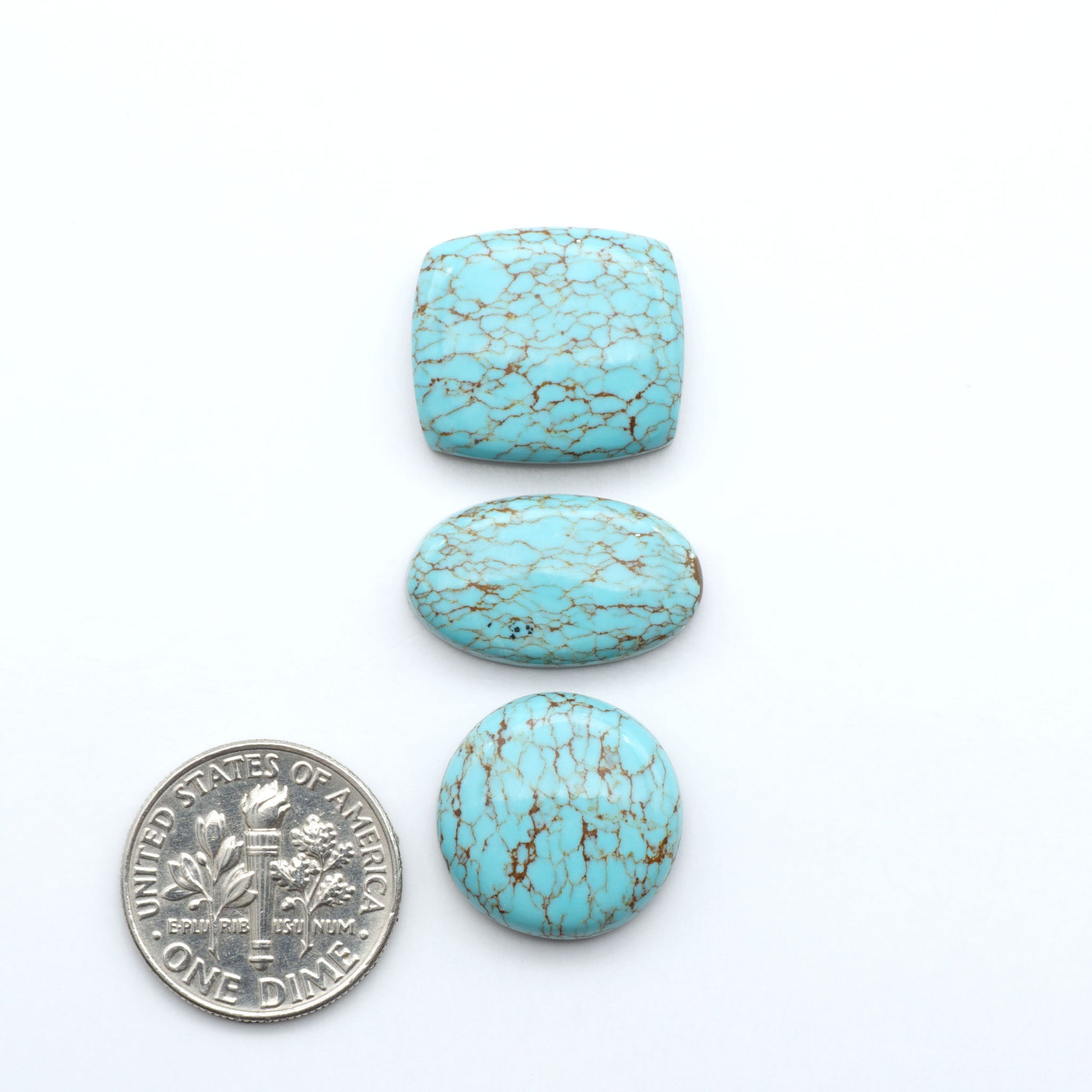 Number 8 Turquoise cabochons, classic color with distinctive matrix, polished stones on a white background with a US dime for scale