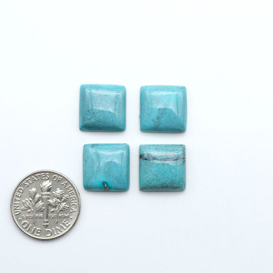 Hubei Cloud Mountain Turquoise cabochons, blue and green color with distinctive matrix, polished stones on a white background with a US dime for scale