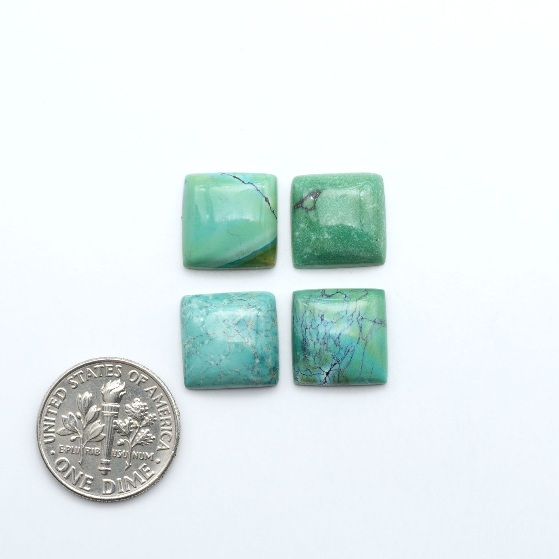 Hubei Cloud Mountain Turquoise cabochons, blue and green color with distinctive matrix, polished stones on a white background with a US dime for scale