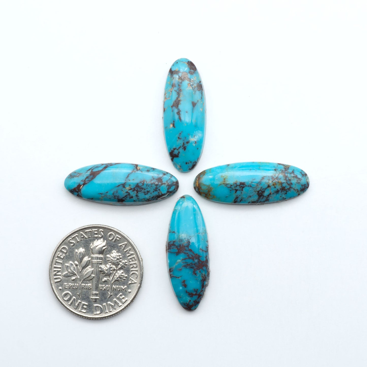 Hubei Cloud Mountain Turquoise cabochons, blue and green color with distinctive matrix, polished stones on a white background with a US dime for scale
