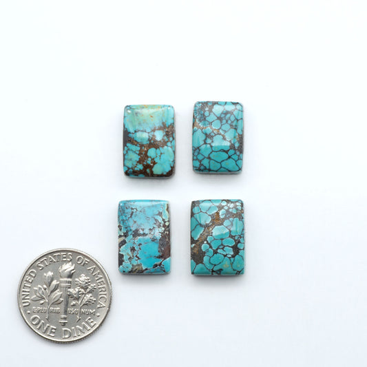Hubei Cloud Mountain Turquoise cabochons, blue and green color with distinctive matrix, polished stones on a white background with a US dime for scale