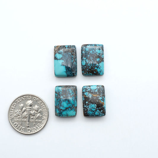 Hubei Cloud Mountain Turquoise cabochons, blue and green color with black matrix, polished stones on a white background with a US dime for scale