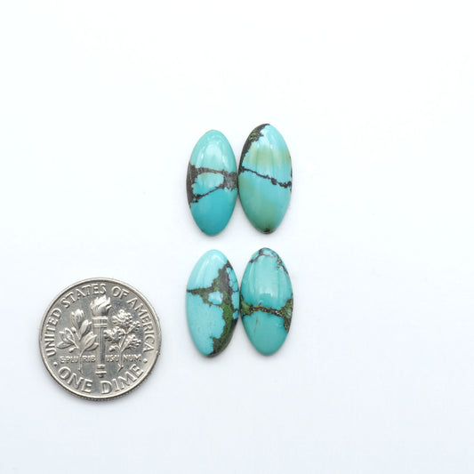 Hubei Cloud Mountain Turquoise cabochons, blue and green color with black matrix, polished stones on a white background with a US dime for scale