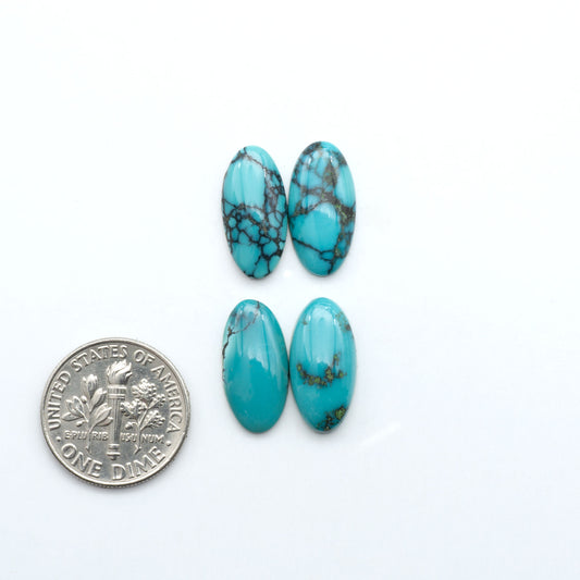 Hubei Cloud Mountain Turquoise cabochons, blue and green color with black matrix, polished stones on a white background with a US dime for scale