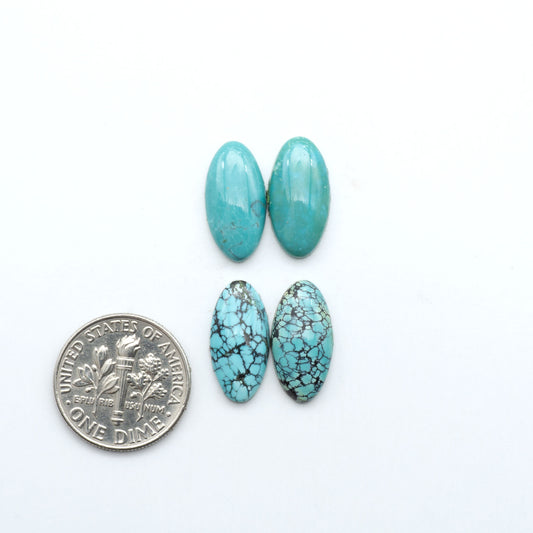 Hubei Cloud Mountain Turquoise cabochons, blue and green color with black matrix, polished stones on a white background with a US dime for scale