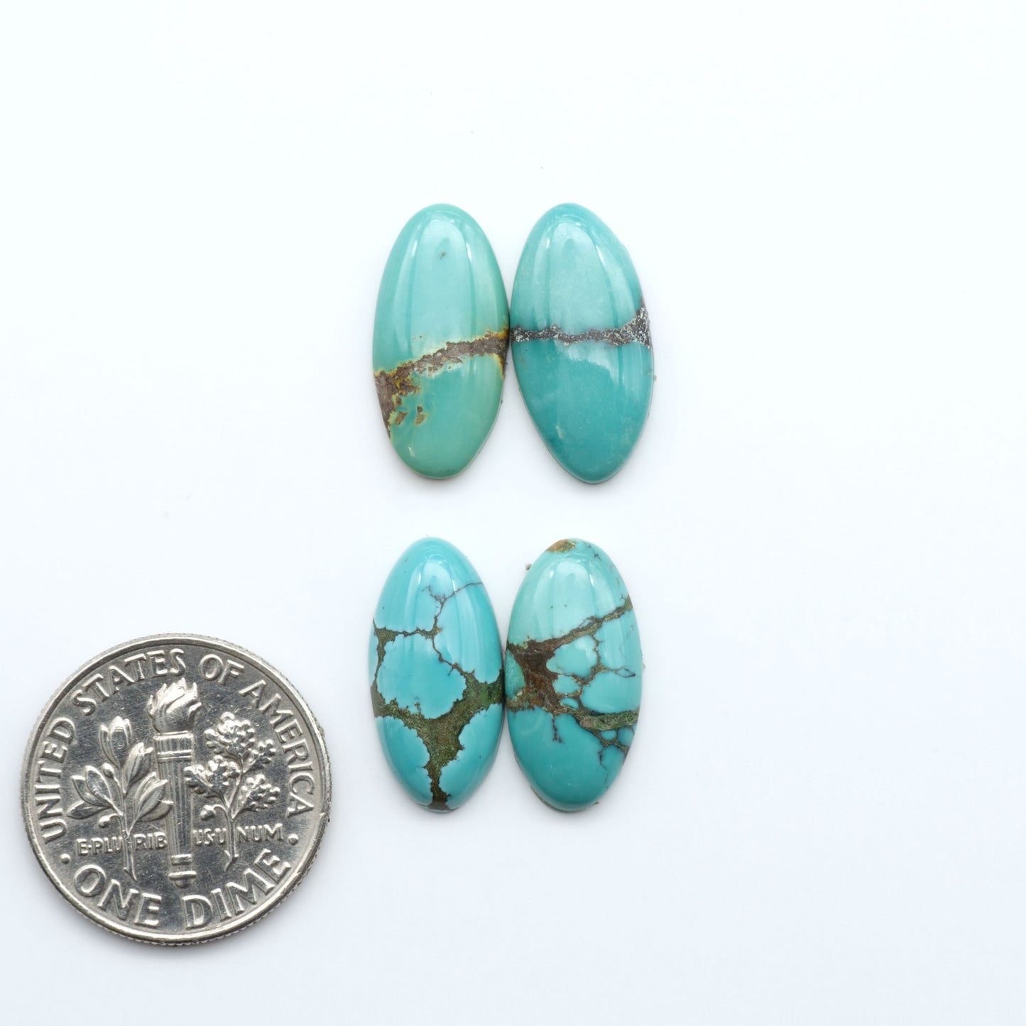 Hubei Cloud Mountain Turquoise cabochons, blue and green color with black matrix, polished stones on a white background with a US dime for scale