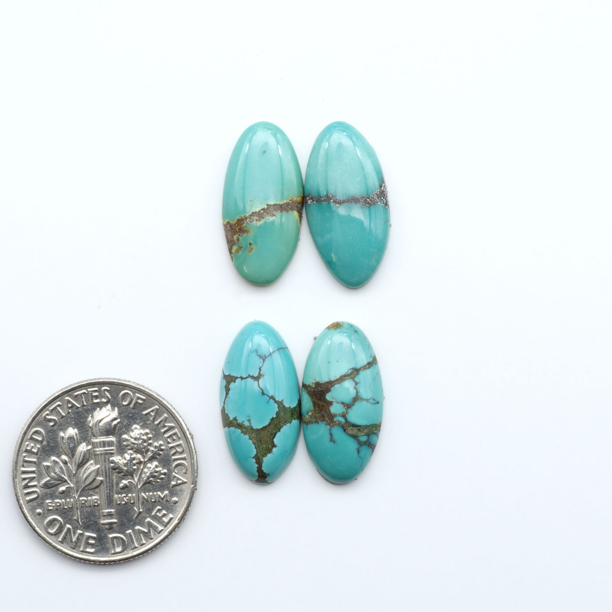 Hubei Cloud Mountain Turquoise cabochons, blue and green color with black matrix, polished stones on a white background with a US dime for scale