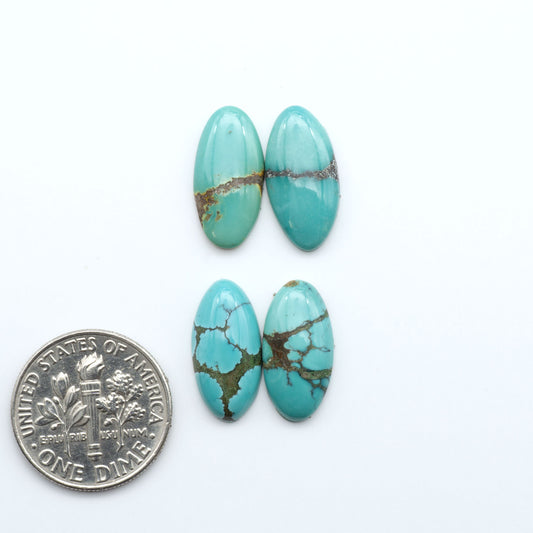Hubei Cloud Mountain Turquoise cabochons, blue and green color with black matrix, polished stones on a white background with a US dime for scale