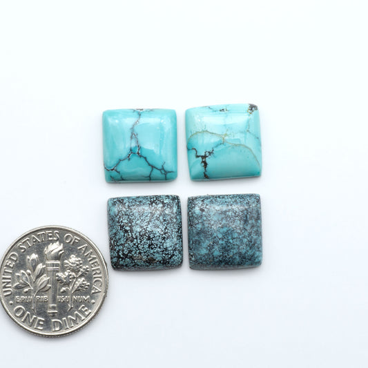 Hubei Cloud Mountain Turquoise cabochons, blue and green color with black matrix, polished stones on a white background with a US dime for scale