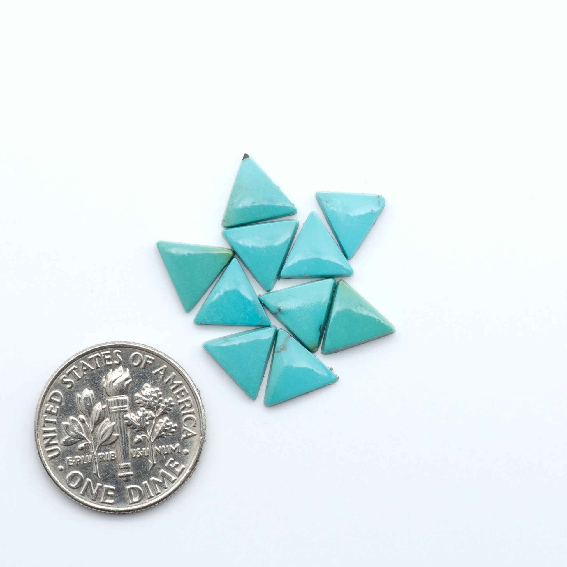 Hubei Cloud Mountain Turquoise cabochons, blue and green color with black matrix, polished stones on a white background with a US dime for scale