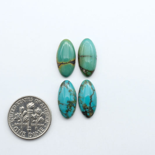 Hubei Cloud Mountain Turquoise cabochons, blue and green color with black matrix, polished stones on a white background, with a US dime for scale