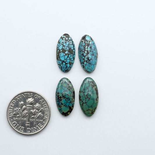 Hubei Cloud Mountain Turquoise cabochons, blue and green color with black matrix, polished stones on a white background, with a US dime for scale