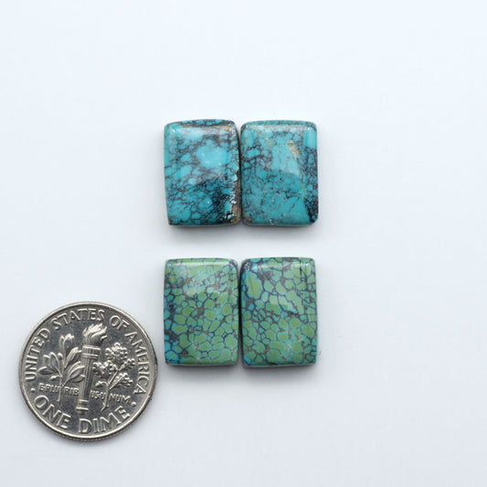 Hubei Cloud Mountain Turquoise cabochons, blue and green color with black matrix, polished stones on a white background, with a US dime for scale